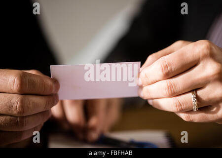 Business people holding card together Stock Photo
