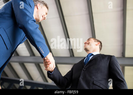 Two smiling businessmen shaking hands Stock Photo