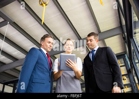 Business people talking together while looking tablet Stock Photo