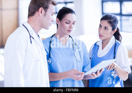 Medical team working on tablet together Stock Photo