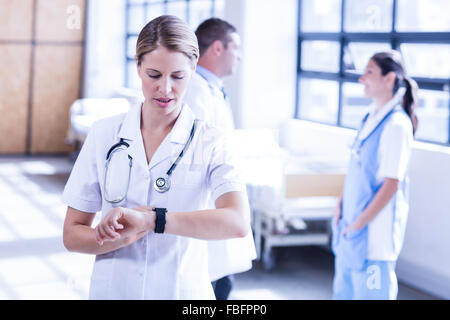 Concentrated doctor typing on screen watch Stock Photo