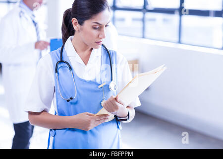Nurse looking at medical files Stock Photo