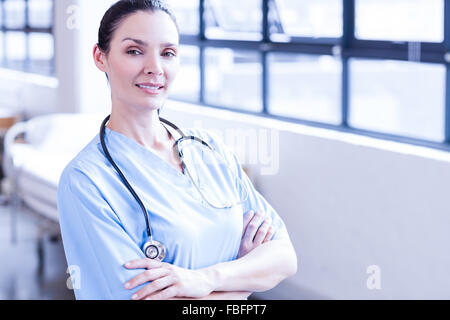 Smiling nurse with arms crossed Stock Photo