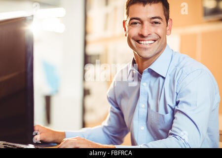 Smiling businessman working on computer Stock Photo