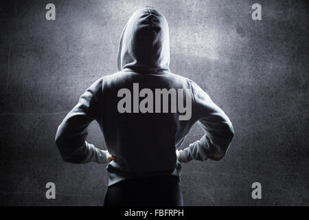 Composite image of rear view of athlete in hood Stock Photo