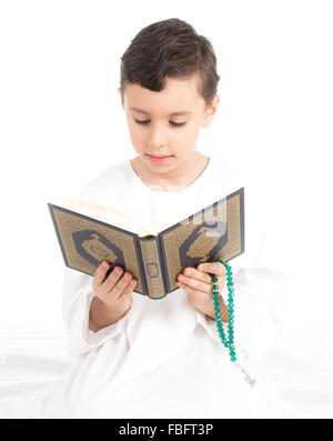 Muslim young boy reading Quran Stock Photo