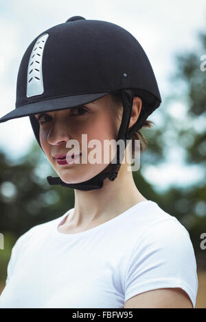 Smiling jockey posing for camera Stock Photo