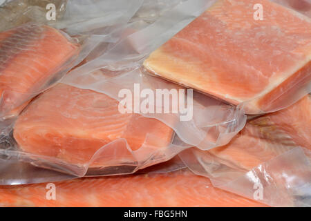 Frozen salmon fillets in vacuum packed plastic packaging Stock Photo