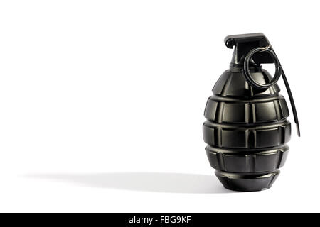 Single unexploded black metal grenade with round pin over white with long shadow and copy space Stock Photo