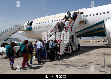 Passengers boarding Oman Airways plane, Seeb International Airport, Muscat, Oman Stock Photo