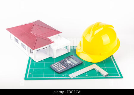 Model of the house and  calculator, Plastic right angle on white background Stock Photo
