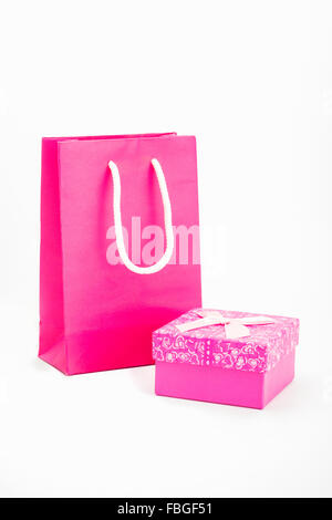 Shopping bags placed pink with pink gift box on white background Stock Photo