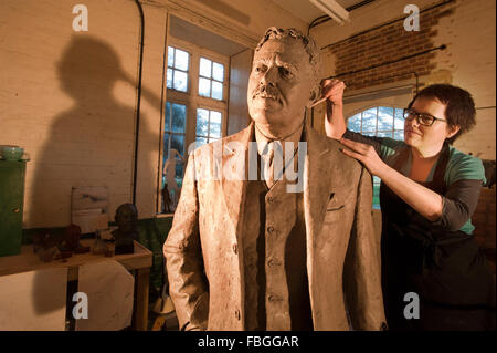 Sculptor Hazel Reeves works on the statue of Sir Nigel Gresley, the designer of the Flying Scotsman, for Kings Cross Station. Stock Photo