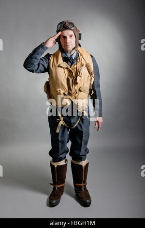 World War Two Royal Air Force fighter pilot / bomber crew member, saluting to the viewer. Pilot is wearing Mae West life jacket. Stock Photo