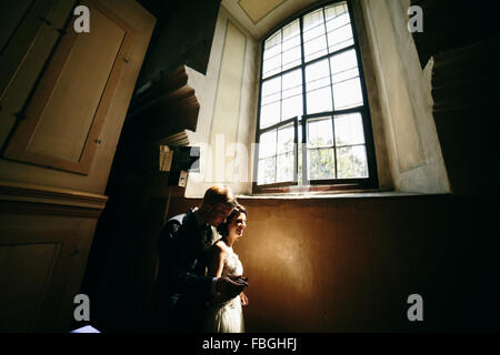 bride and groom on the background of a window. Stock Photo