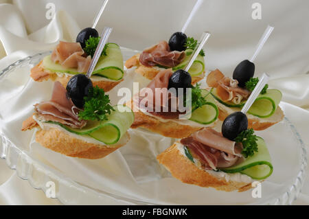 Mini sandwiches with ham and cucumber on a baguette Stock Photo