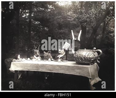 'The Mad Hatter's tea party' scene from 1915 silent movie adaptation of 'Alice in Wonderland' by Lewis Carroll directed by W.W. Young. The photograph shows from left to right: Viola Savoy as Alice, Herbert Rice as the White Rabbit, Louis Merkle as the Dormouse and William Tilden as the Mad Hatter. See description for more information. Stock Photo