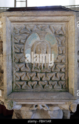 Detail of the 14th century font. St John the Baptist's head on a charger (dish), St Michael's Church, Irstead, Norfolk Stock Photo