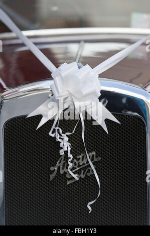 Flower and white ribbon on an Austin Six wedding car on a wedding day Stock Photo