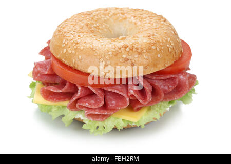 Bagel sandwich for breakfast with salami ham, cream cheese, tomatoes and lettuce isolated on a white background Stock Photo