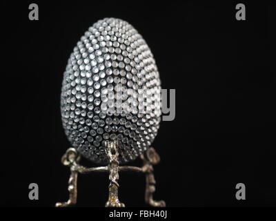 Easter Egg covered in crystals on a silver stand Stock Photo