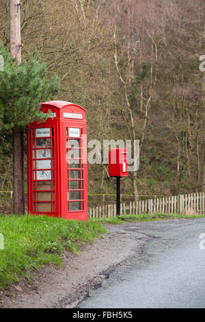 Red telephone box and red post box with finger post road sign