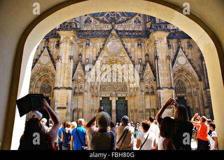 PRAGUE, CZECH REPUBLIC - JULY 19, 2014. Tourists looking at the St. Vitus Cathedral in Prague. Stock Photo