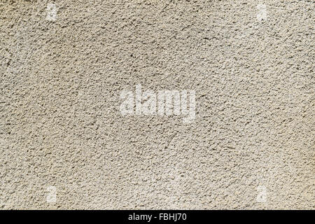 Texture of a wall from the made foam plaster. Types of external coverings of the building. Stock Photo