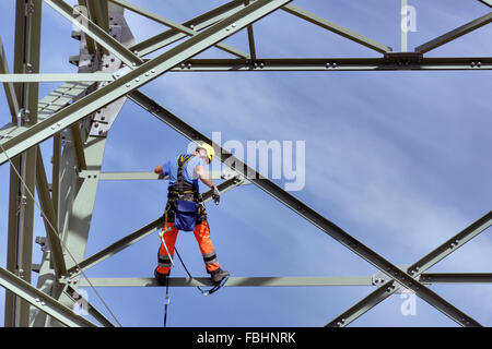 Man working on high-voltage power pylon, Thuringian Forest Stock Photo
