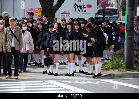 10 April, 2012. Tokyo, Japan. Japanese girl students waiting at the crossroad Stock Photo