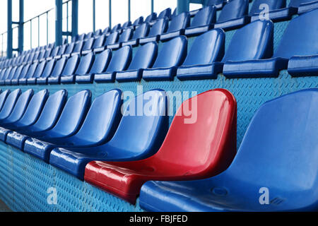 Empty plastic seats at stadium, open door sports arena. Stock Photo