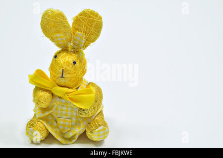 close up of a yellow Easter bunny, female,  on white background, horizontal, dress, dressed,  checkered Stock Photo