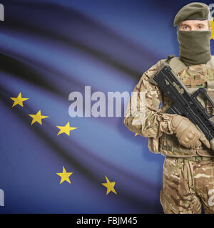 Soldier with machine gun and USA state flag on background series - Alaska Stock Photo