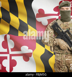 Soldier with machine gun and USA state flag on background series - Maryland Stock Photo