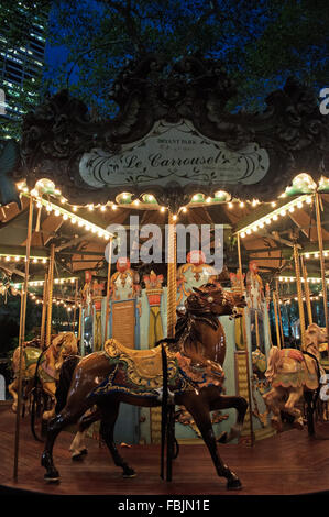 New York, United States of America: night view of Le Carrousel in Bryant Park, an old style carousel in the center of the public park Stock Photo