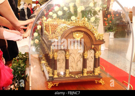 Worshipers place hands on the relics of St. Therese of Lisieux at Lady of Seven Sorrows church, Bratislava, Slovakia. Stock Photo