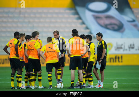 Dortmund's coach Thomas Tuchel (m) advises his team at half time during the test match between Jeonbuk Hyundai Motors FC vs. Borussia Dortmund in the Zabeel Stadium in Dubai, UAE, 15 January 2016. Photo: Guido Kirchner/dpa Stock Photo