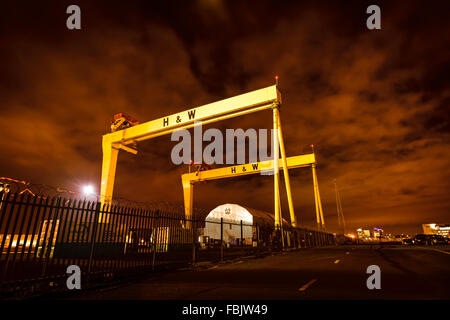 A night time photograph of the huge Harland and Wolff cranes in the Belfast shipyard where Titanic ship was built. Stock Photo