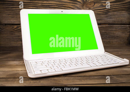 Open laptop isolated screen on old wooden desk Stock Photo