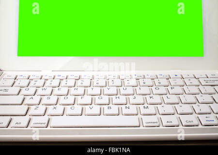 Open laptop isolated screen on old wooden desk Stock Photo