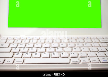 Open laptop isolated screen on old wooden desk Stock Photo
