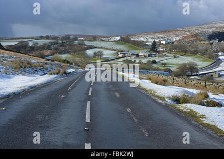 Melting snow and ice on the road near Merrivale in Dartmoor National Park, Devon, England. Stock Photo