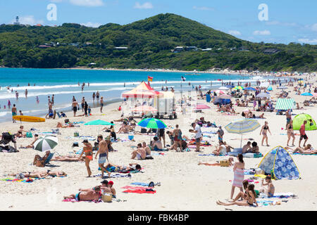 busy Main Beach in Byron bay on new south wales north coast, with lighthouse in distance,Australia Stock Photo