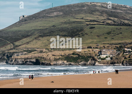 Men, women and dogs strolling along the Cantabrian Sea, Sand beach, Bilbao, Spain, Stock Photo