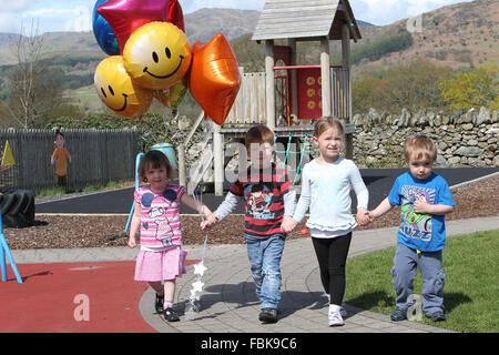 Children walking with balloons in there hands at a nursery Stock Photo