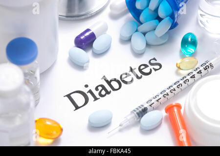 Diabetes concept with insulin, syringe, vials, pills, and stethoscope. Stock Photo