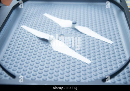 Small model propellers lying on print screen machine black plastic surface with bubble pattern. Stock Photo