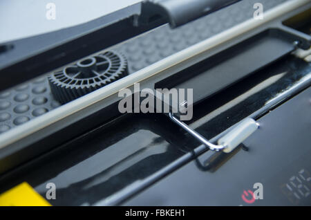 Closeup black print screen machine showing mechanical details in process. Stock Photo