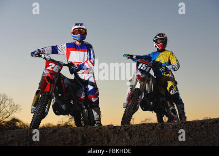 Motocross bikers on dirt track Stock Photo