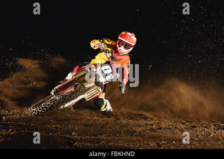 Motocross biker on dirt track Stock Photo